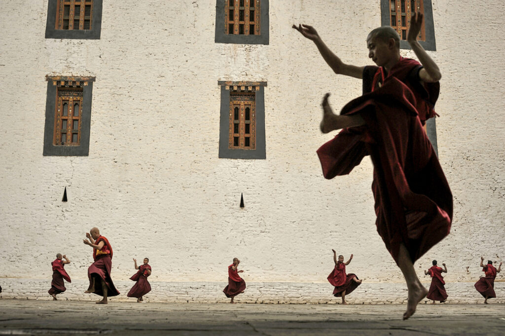 Monks in front of a building